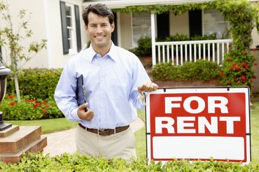Property Manager with For Rent sign
