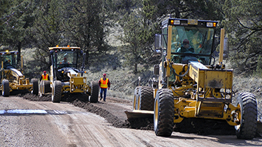 Graders working to smooth a road