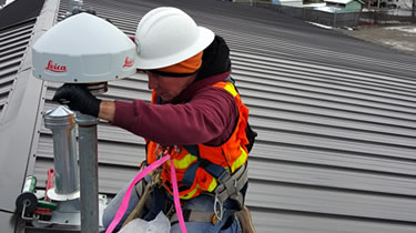 Employee installing a corrector station
