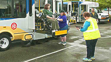 Person in wheelchair exiting bus