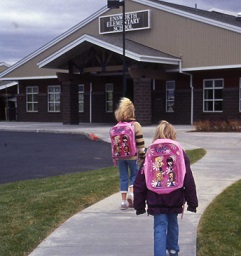 Two kids walk to school