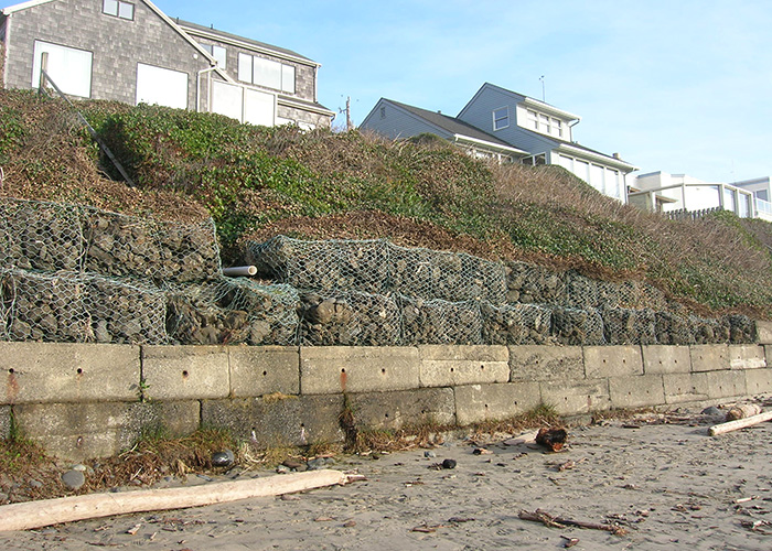 A sea-wall protects homes from sand and water