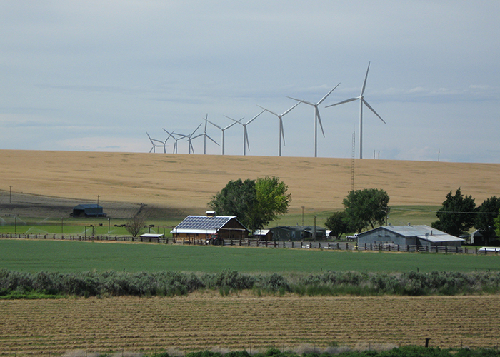 View of wind turbines overlooking a farm