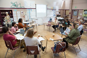 A picture of teachers in a meeting assessing student data