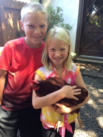 boy and girl holding a chicken