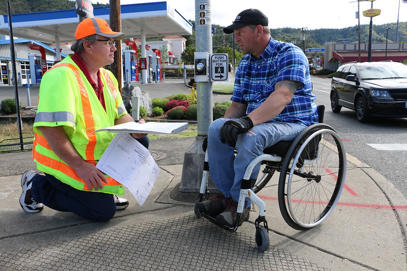 ODOT worker testing curb ramp design with wheelchair user.
