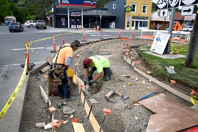 Image of a construction crew building a new curb ramp on a city street.