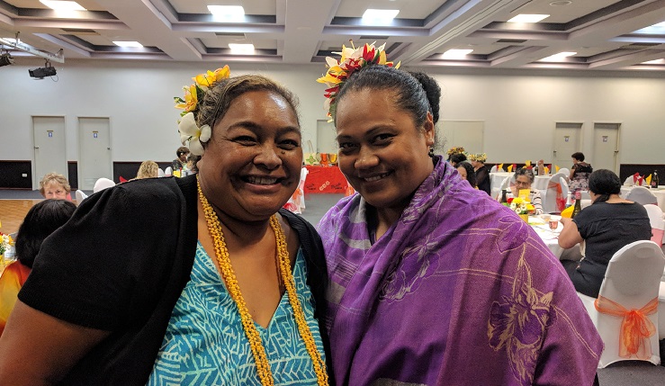 Two Pacific Islander women smiling at conference
