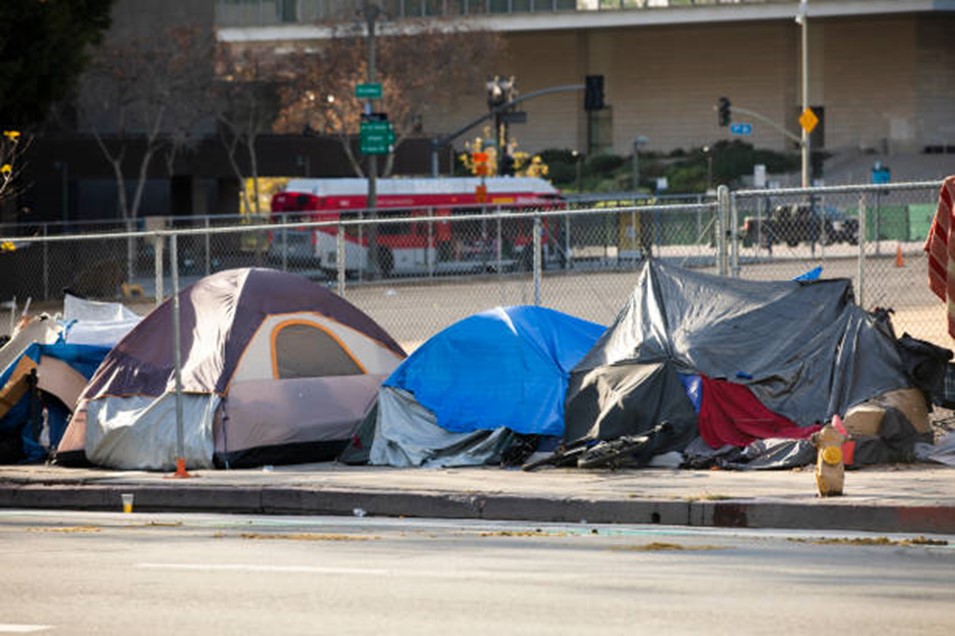 Homeless tents lined up on sidewalk.
