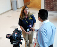 Local health official being interviewed by TV reporter