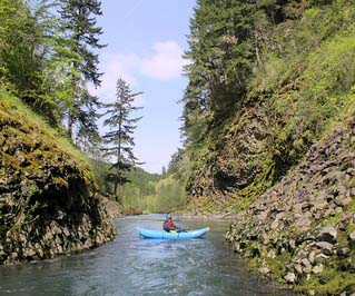 Kayak floating down a narrow river