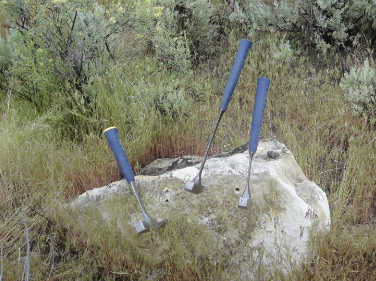 image of rock hammers on rock outcrop