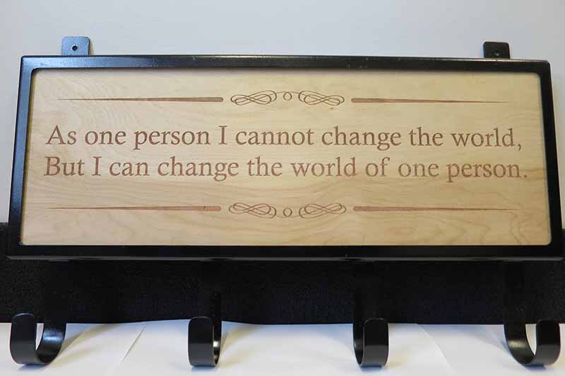 sign that says "As one person I cannot change the world, but I can change the world of one person."