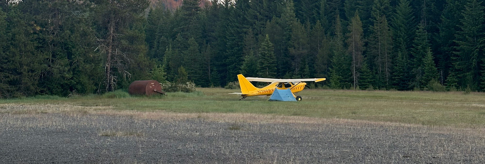 tent camping next to yellow plane