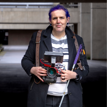 Katt Green holding a camera.