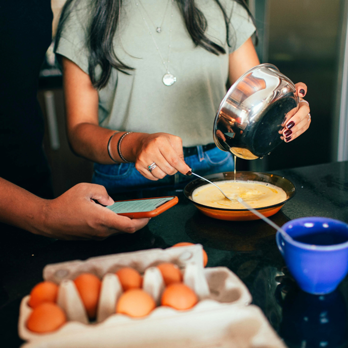A photo of a person cooking breakfast.