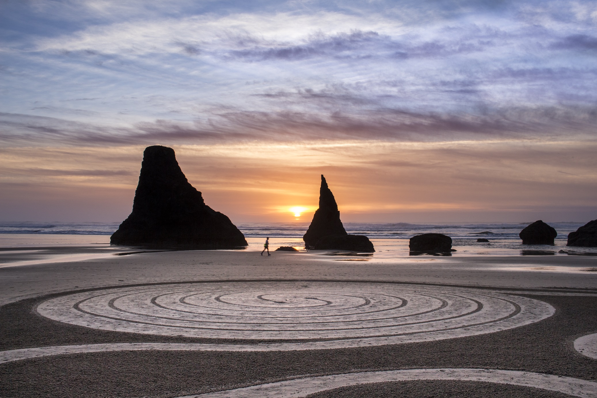 Circles dran in the sand at the beach at sunset