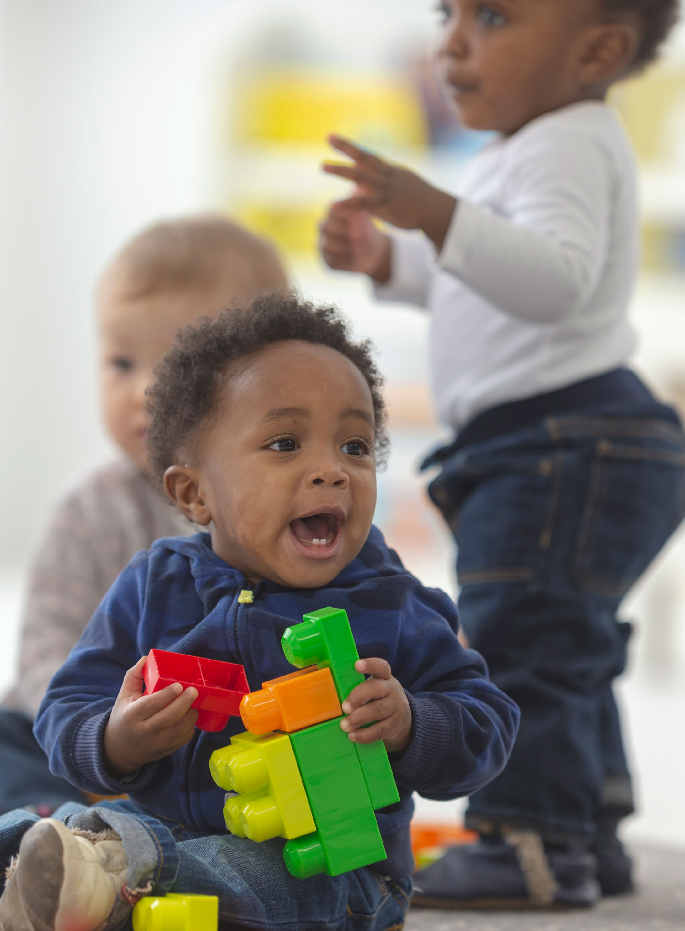 child playing with blocks in group