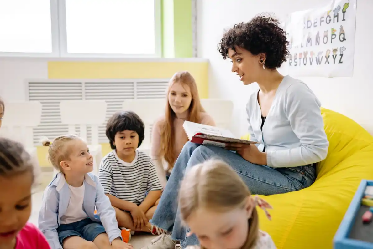 A teacher reads to young children in a classroom