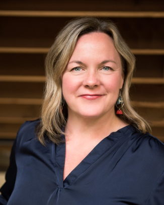 Jennifer, shoulder length blond hair, wearing a blue v neck blouse.