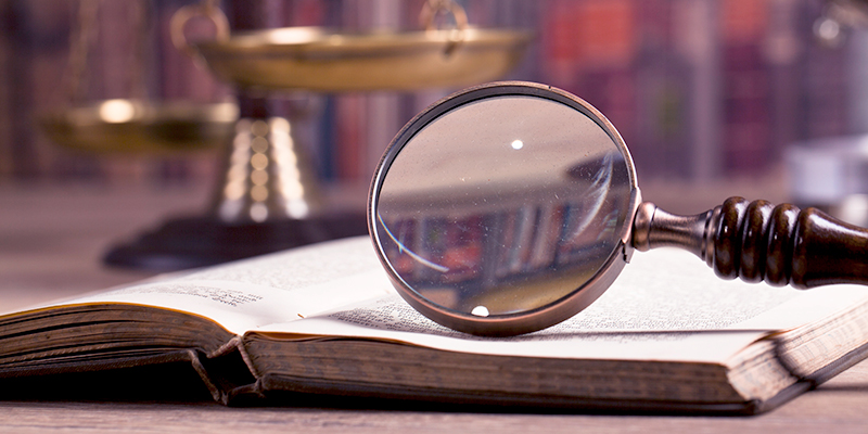 Magnifine glass and law book