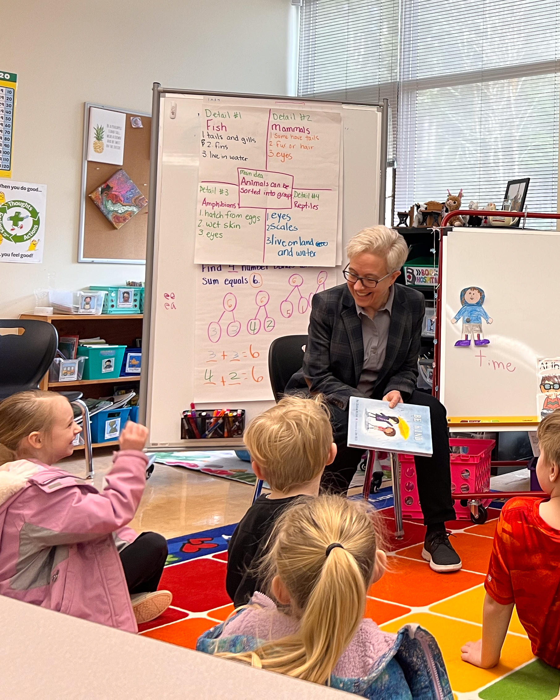 Tina reading a book to children at a school