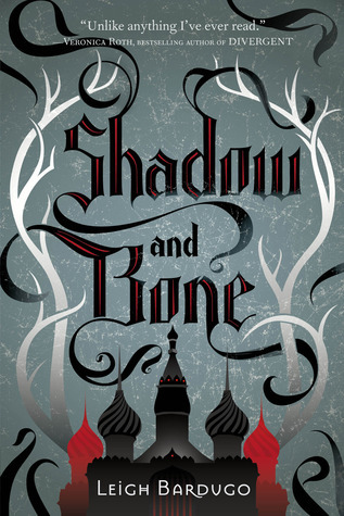 Book Cover for Shadow and Bone, winding silver and black trees with a black and red castle in the foreground.