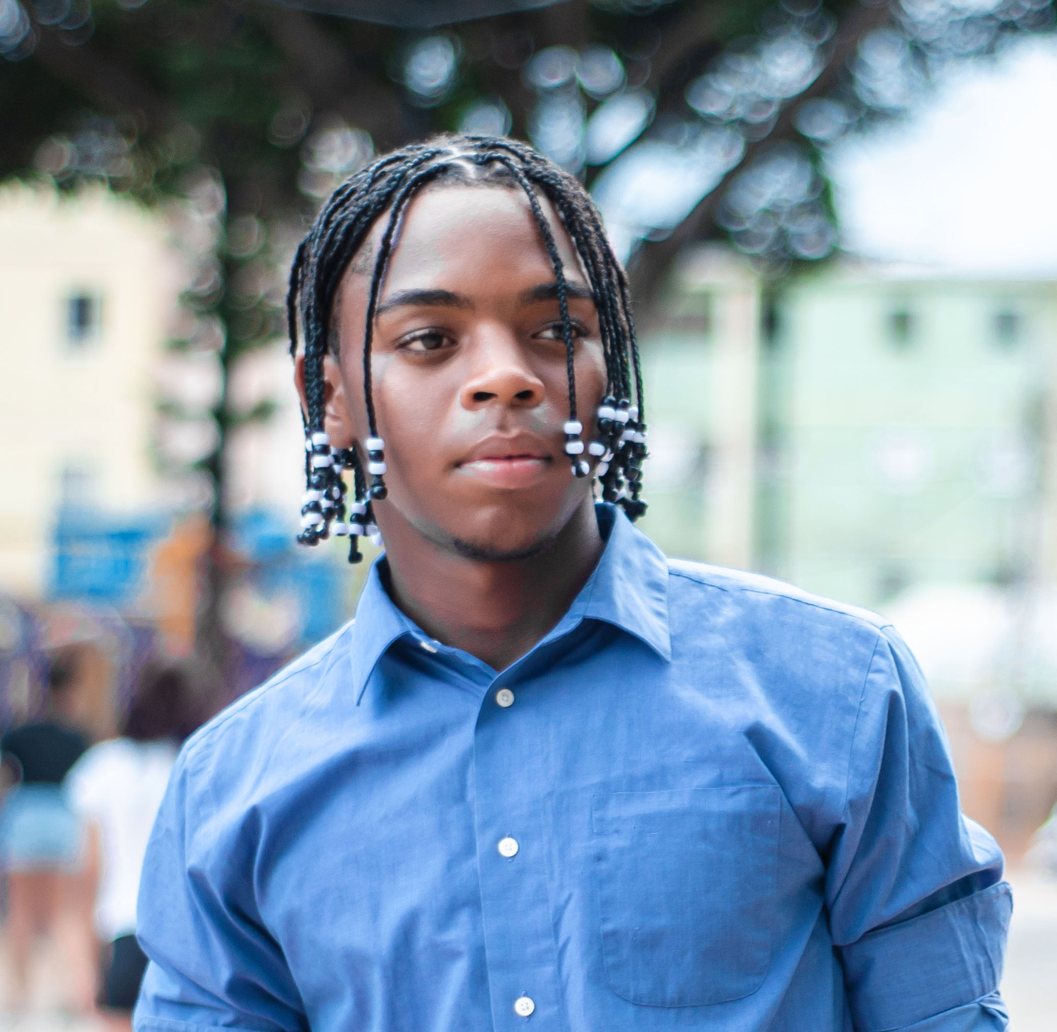 Young man with adornments on his braids