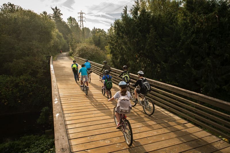 People riding bikes accross bridge