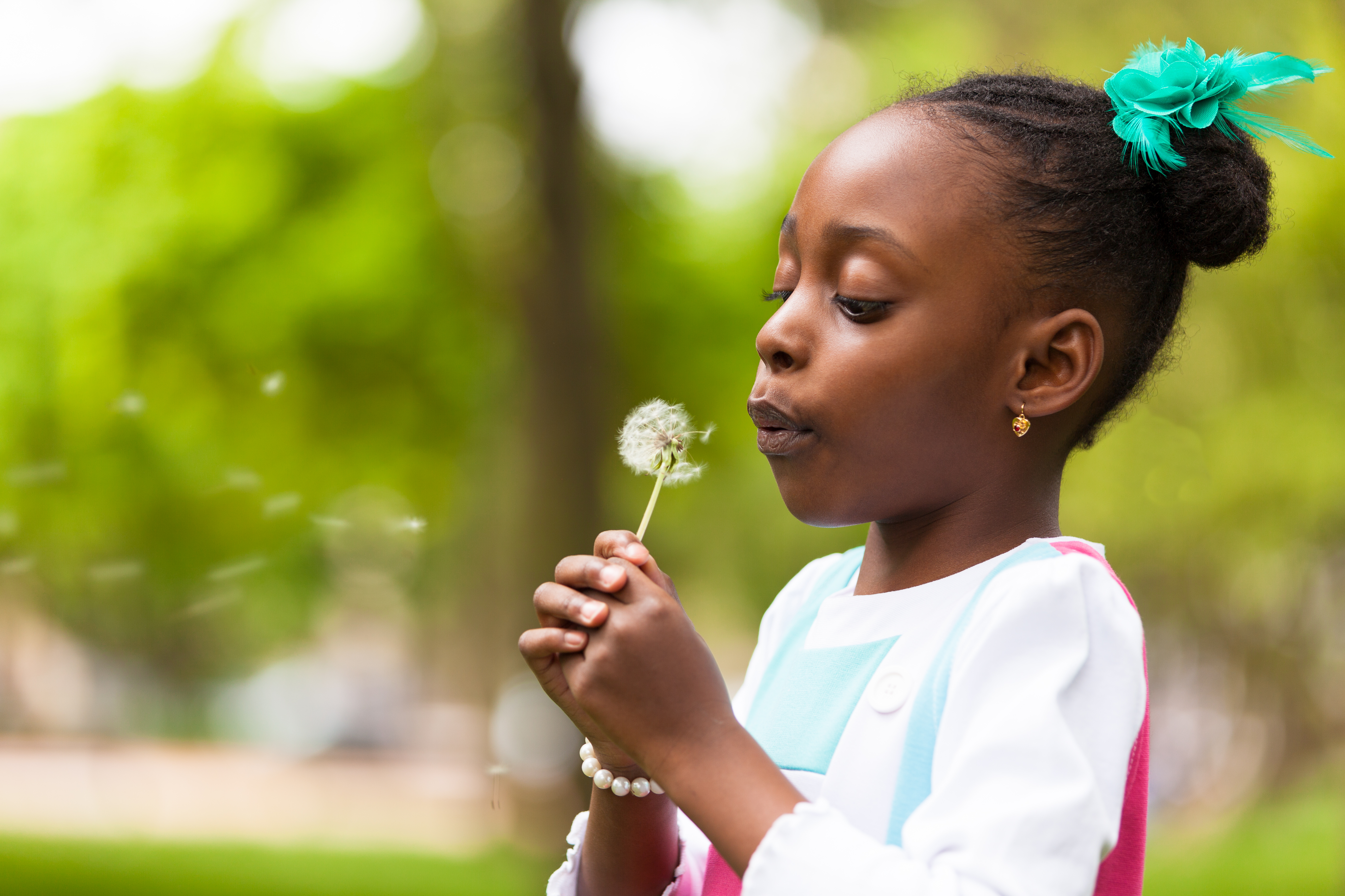 little girl blowing wish