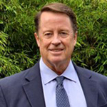 Photo of David, a man with short brown hair that is combed to the left and he is smiling at the camera.
