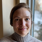 Photo of Katie, a woman with shoulder length brown hair that is pinned up.  