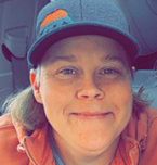 Photo of Kelsey, a woman with shoulder length sandy brown hair. She is looking and smiling at the camera. 