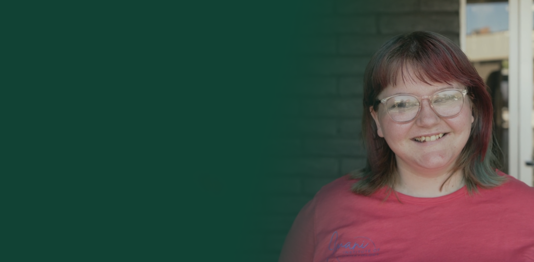 Kayla smiling outside her workplace