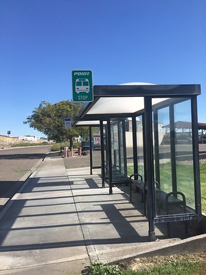 Image of a bus stop with shelter and benches
