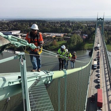 Bridge inspectors climbing up a bridge