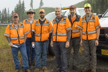 A group of roadway engineers standing outside and smiling at the camera