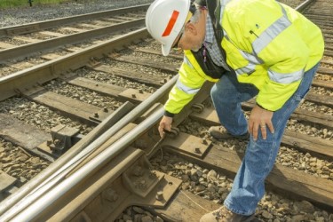Employee inspecting a railroad track