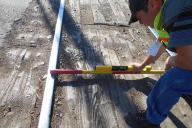 Employee checking safety of railroad ties