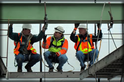 Bridge inspectors evaluate a metal beam