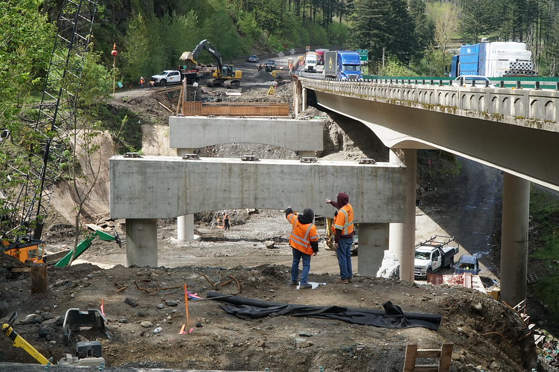 Bridge inspectors evaluate a metal beam