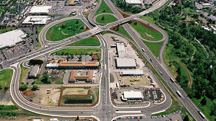 A view of two highway overpasses and surrounding green grass from above