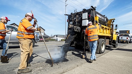 Maintenance crew patches potholes on OR 99E in Canby.
