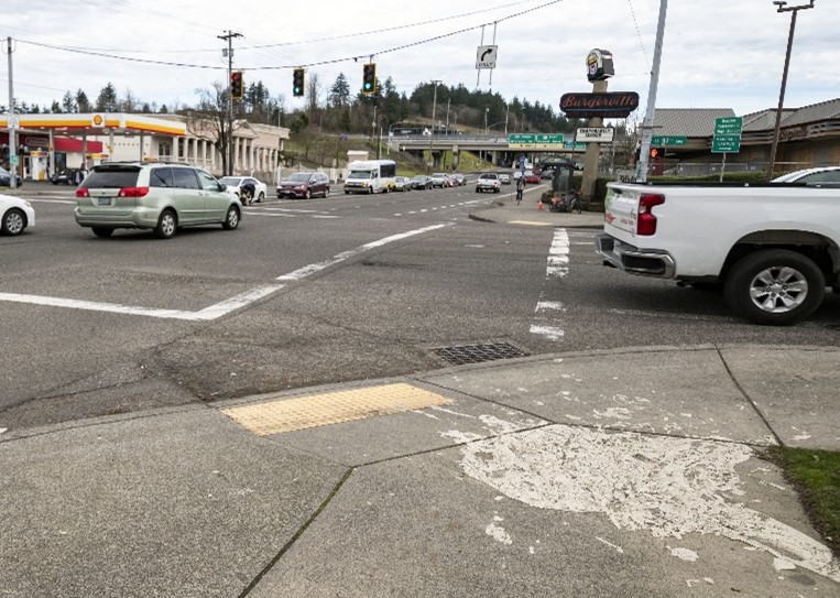 Example photo of a lowered crosswalk button at a crosswalk.