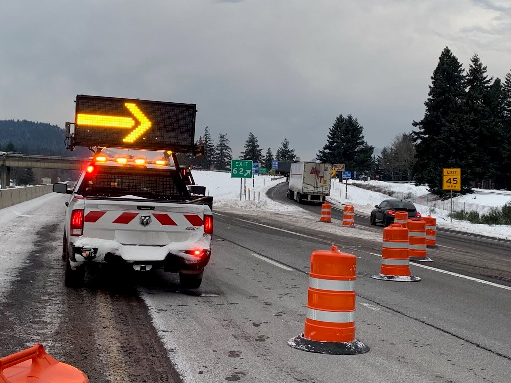 A truck with a lighted arrow diverts traffic