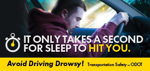 Drowsy Driving poster shows a man falling asleep behind the wheel. Text reads, It Only Takes A Second For Sleep To Hit You .