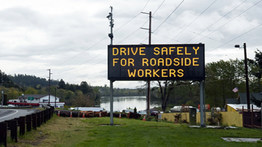 Photo of a digital sign that reads Drive Safely for Roadside Workers