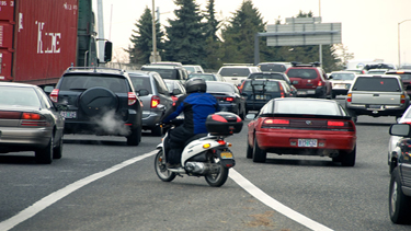 Photo of a man on a motorbike merging into traffic