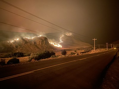 Hillside on fire next to Oregon roadway