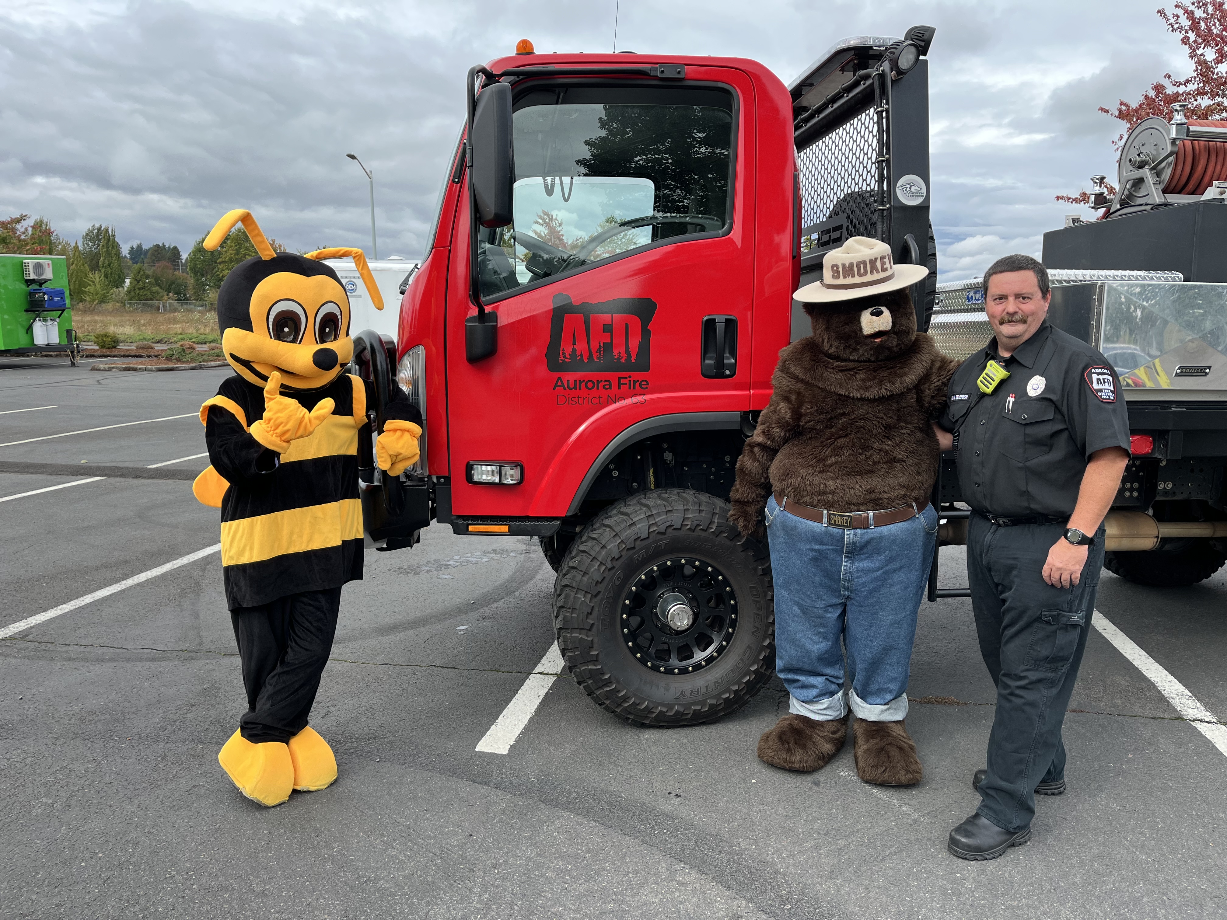 Smoke the Bear and Buzzy the Bee posing for a photo
